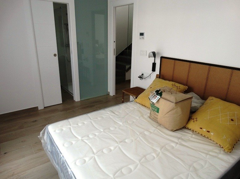 Bright modern bedroom with wooden floors and minimalist decor in a 3-bedroom semi-detached villa in Pilar de la Horadada
