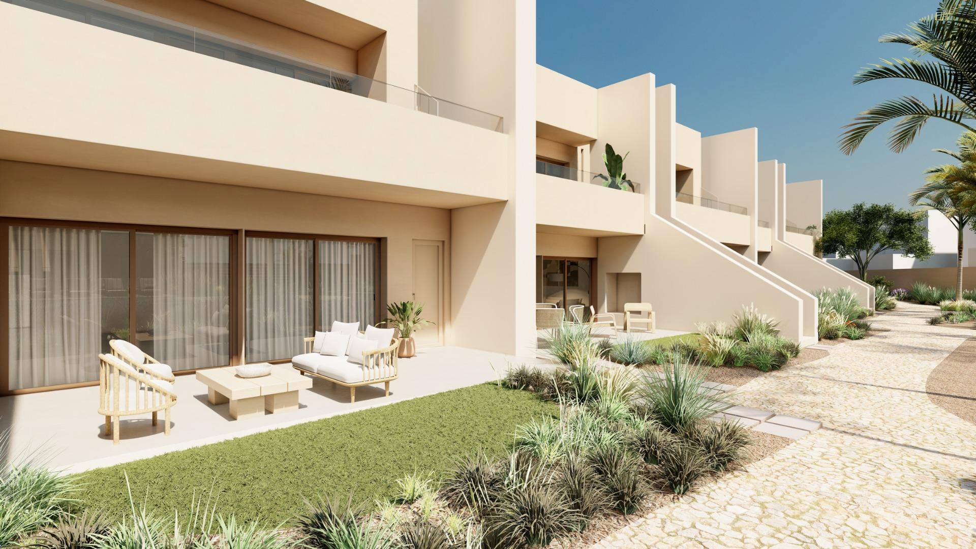 Sunlit modern penthouse exterior with private terrace and landscaped pathway in Roda Golf, San Javier new build.