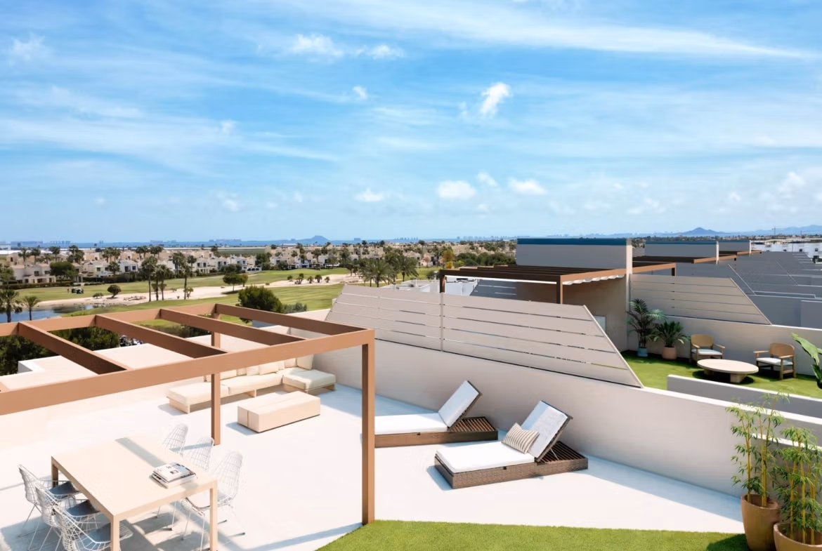 Sun-drenched spacious terrace with modern pergola overlooking landscaped golf course at a new 3-bedroom bungalow in Roda Golf, San Javier.