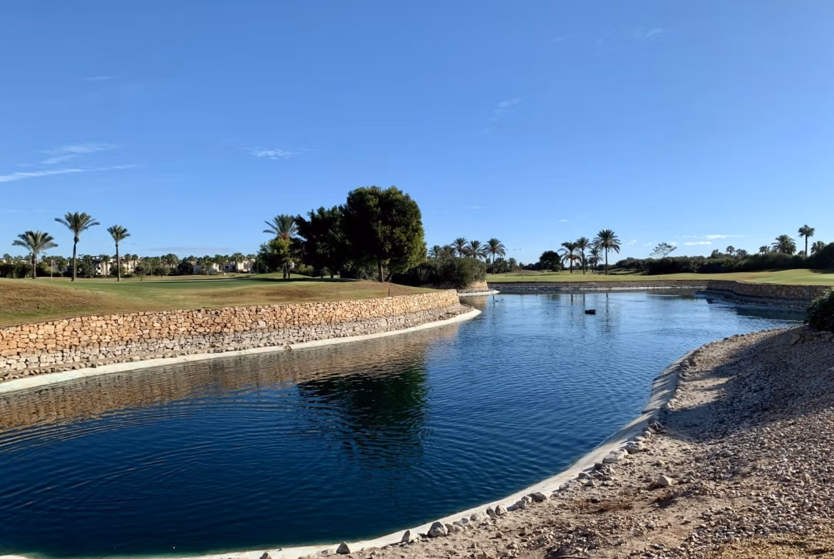 Tranquil landscaped golf course with water feature and palm trees near spacious new build bungalow in Roda Golf, San Javier