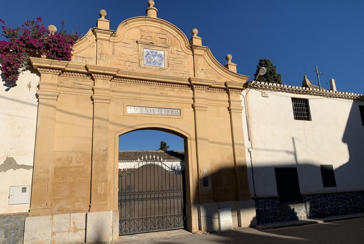 Ornate historic entrance gate with traditional Mediterranean architecture, highlighting the charming surroundings of Roda Golf in San Javier.