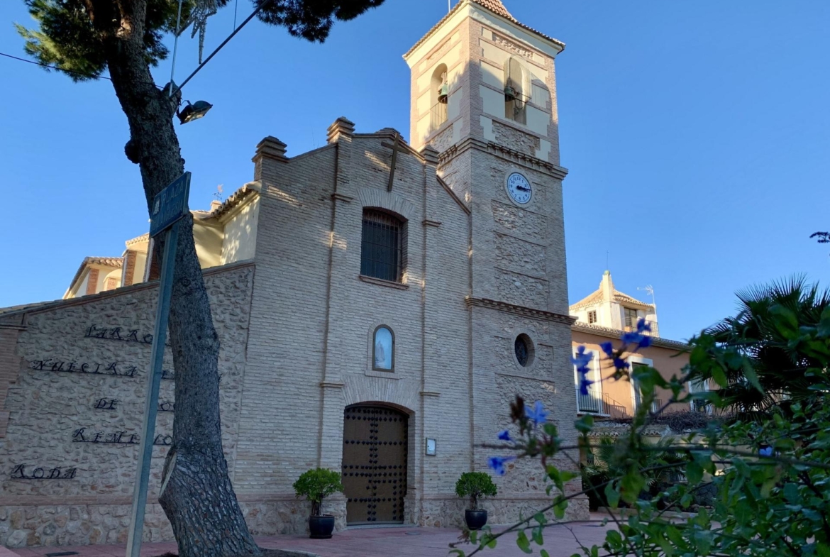 Historic charming church near the modern new build 3-bedroom penthouse at Roda Golf, San Javier under clear blue skies
