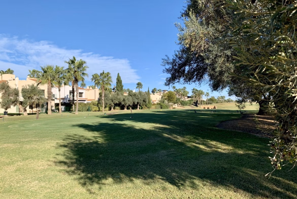 Sunlit exterior view of spacious new build 3-bedroom ground floor bungalow overlooking lush landscaped golf course in Roda Golf, San Javier.