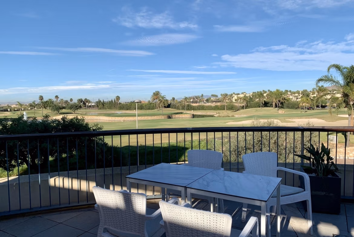 Sun-drenched terrace with modern dining set overlooking manicured golf course at spacious 3-bedroom bungalow in Roda Golf, San Javier