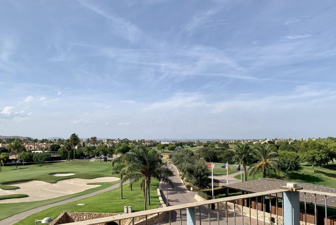 Panoramic sun-drenched view from a modern 3-bedroom penthouse solarium overlooking Roda Golf course in San Javier.