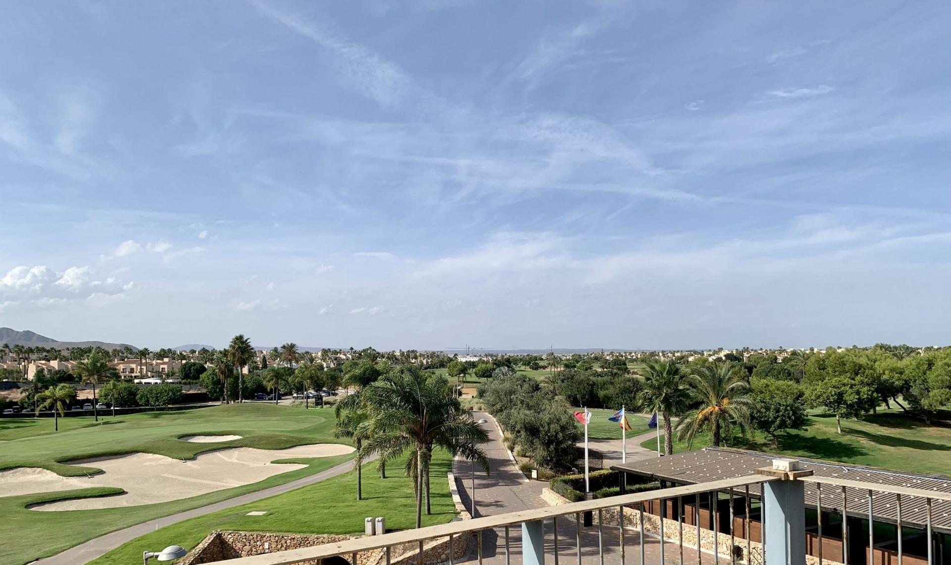Panoramic sun-drenched view from a modern 3-bedroom penthouse solarium overlooking Roda Golf course in San Javier.