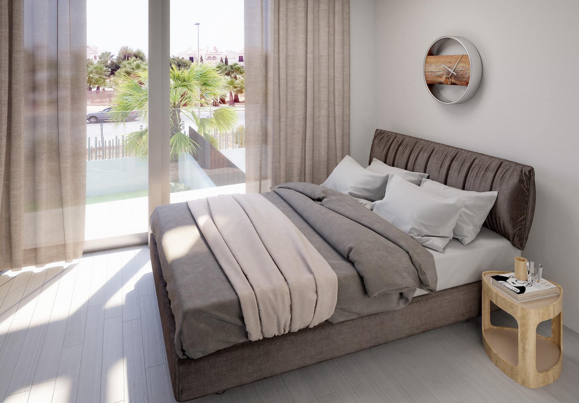 Bright, modern 3-bedroom villa bedroom with plush bed, soft linens, floor-to-ceiling windows, and pool view in Villamartin, Orihuela Costa.