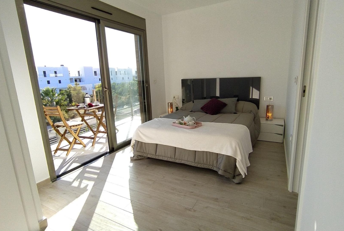 Bright modern bedroom with terrace access in a stylish 3-bedroom villa in Villamartin, Orihuela Costa.
