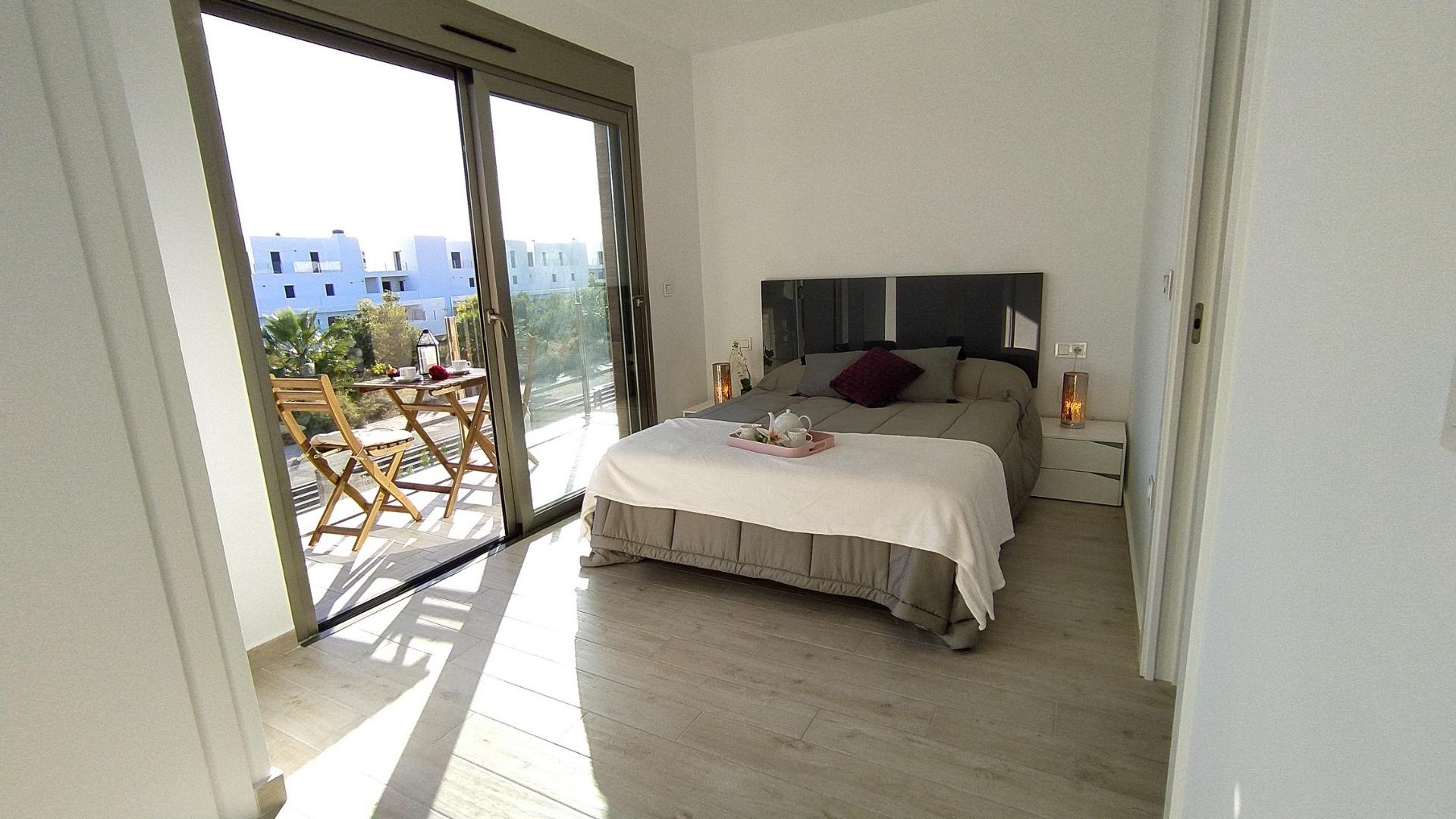 Bright modern bedroom with terrace access in a stylish 3-bedroom villa in Villamartin, Orihuela Costa.
