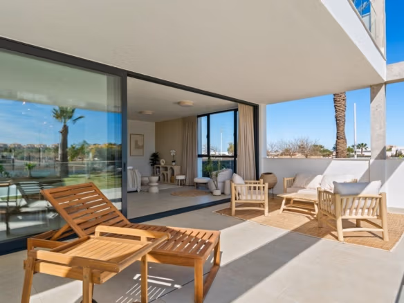 Sunny private solarium terrace with modern wooden loungers and seating in elevated 2-bedroom penthouse, Mar de Cristal.