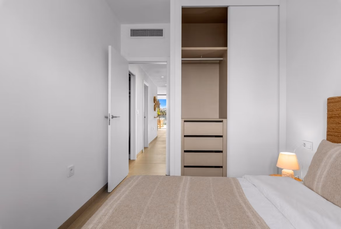 Bright, modern bedroom with built-in wardrobe in a 2-bedroom penthouse, featuring sleek design and neutral tones in Mar de Cristal.
