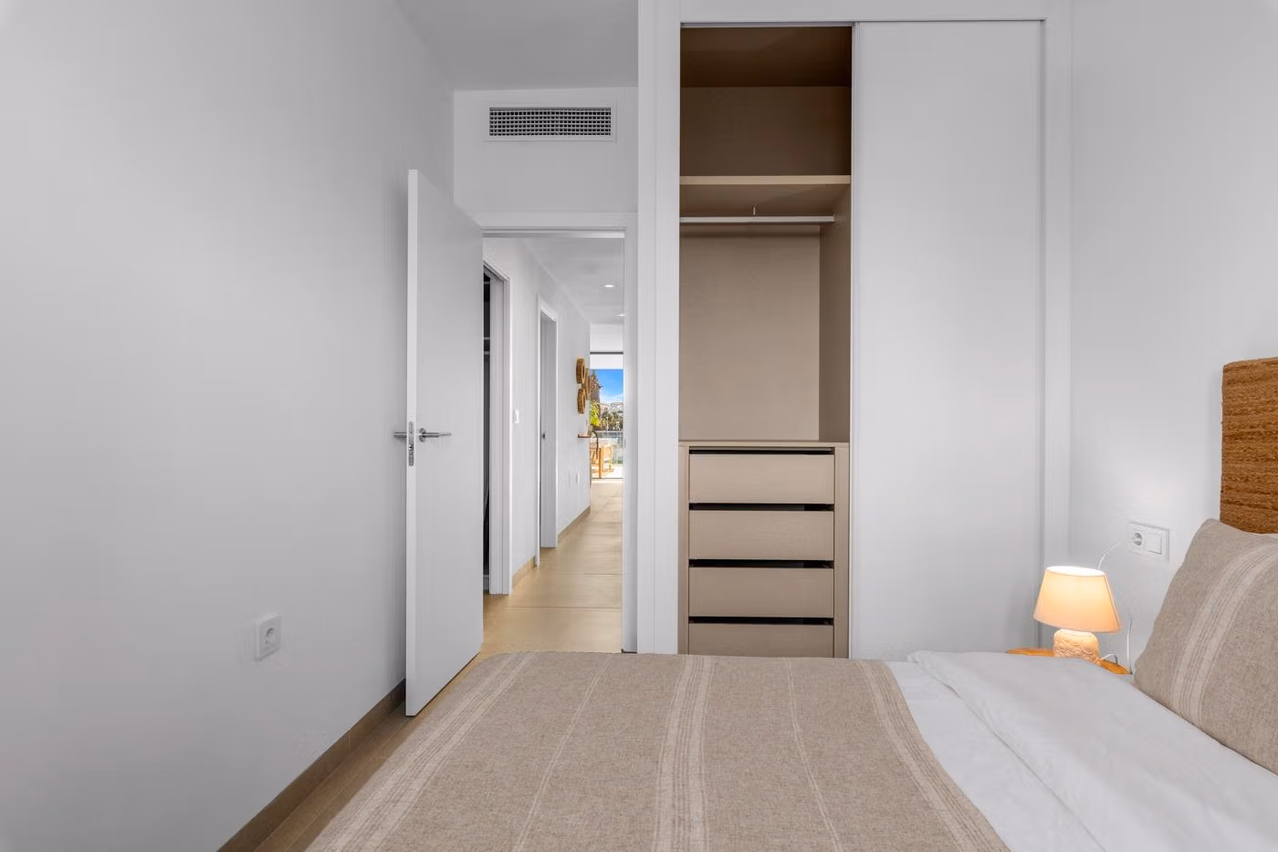 Bright, modern bedroom with built-in wardrobe in a 2-bedroom penthouse, featuring sleek design and neutral tones in Mar de Cristal.