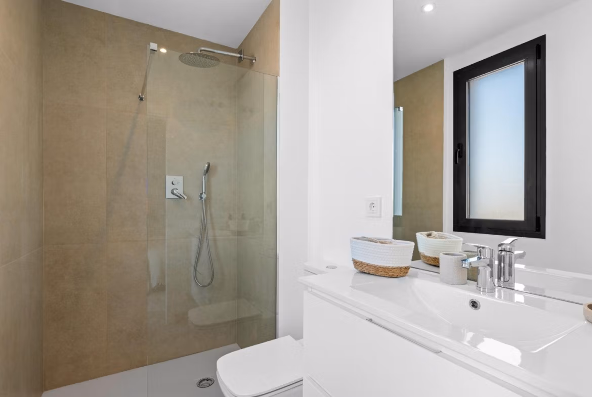 Modern, bright bathroom with walk-in shower and sleek fixtures in elevated 2-bedroom penthouse in Mar de Cristal