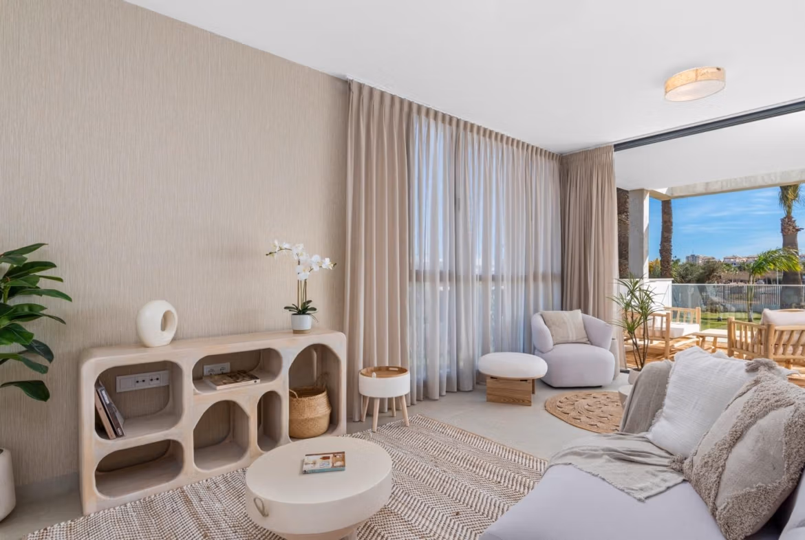 Bright and elegant living room in elevated 2-bedroom penthouse with private solarium, Mar de Cristal, featuring modern decor and garden views.