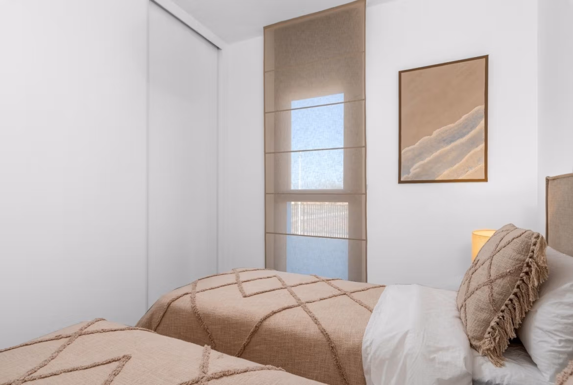 Bright and elegant two-bedroom penthouse bedroom with soft neutral tones and stylish decor in Mar de Cristal new build.