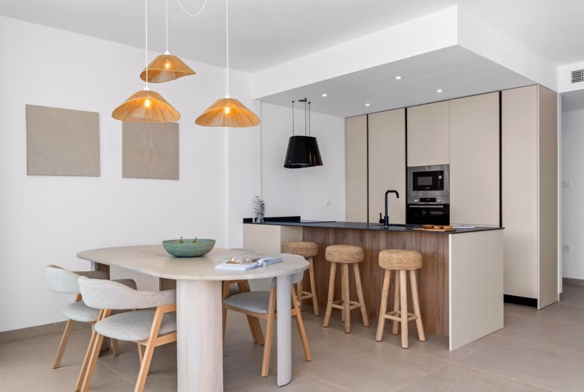 Bright modern open-plan kitchen and dining area with elegant lighting in a 2-bedroom penthouse in Mar de Cristal.