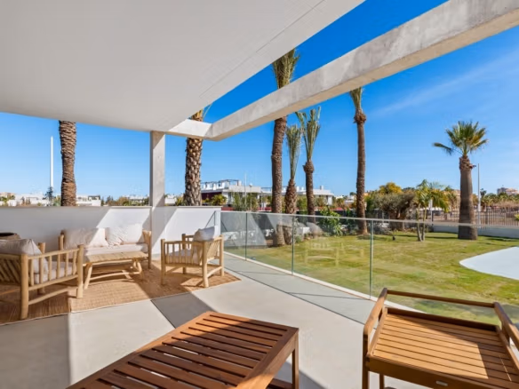 Sun-drenched, spacious terrace with modern seating overlooking landscaped gardens in elevated 2-bedroom penthouse, Mar de Cristal.