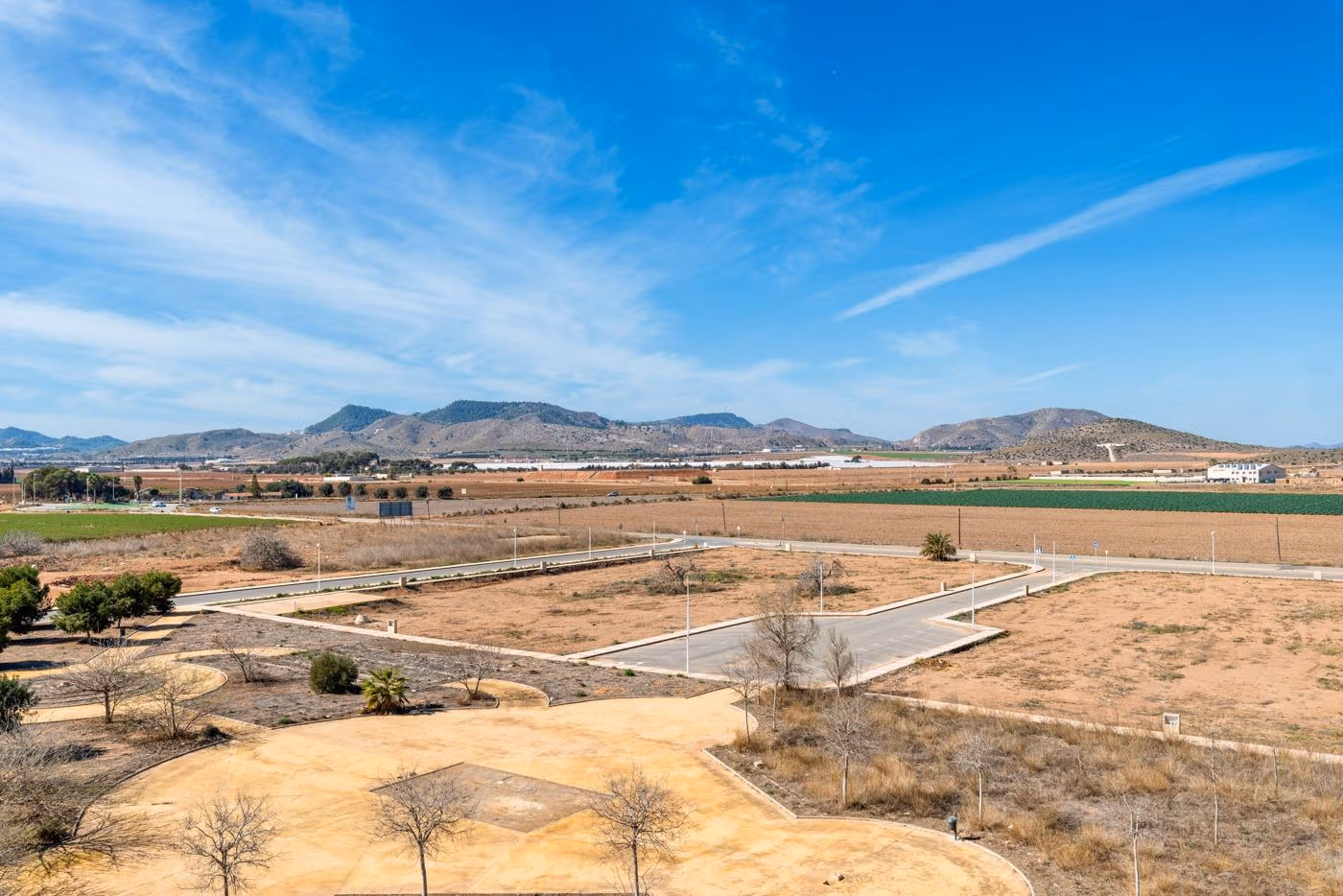 Panoramic sun-drenched view of arid landscape and road infrastructure at elevated new build 2 bedroom penthouse site in Mar de Cristal
