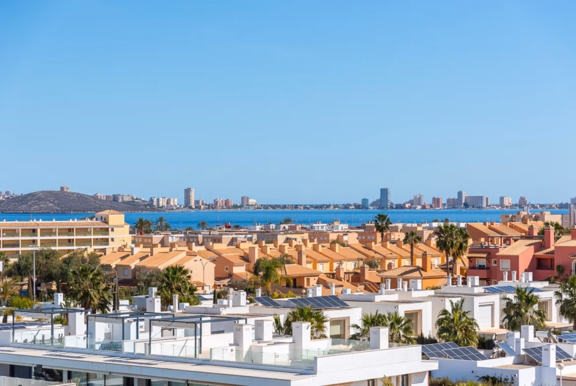 Panoramic sea view over sunlit rooftops and modern terraces from the elevated 2-bedroom penthouse with private solarium in Mar de Cristal.