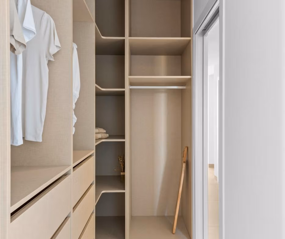 Bright and modern walk-in closet with sleek built-in storage in luxury 2 bedroom penthouse, Mar de Cristal.