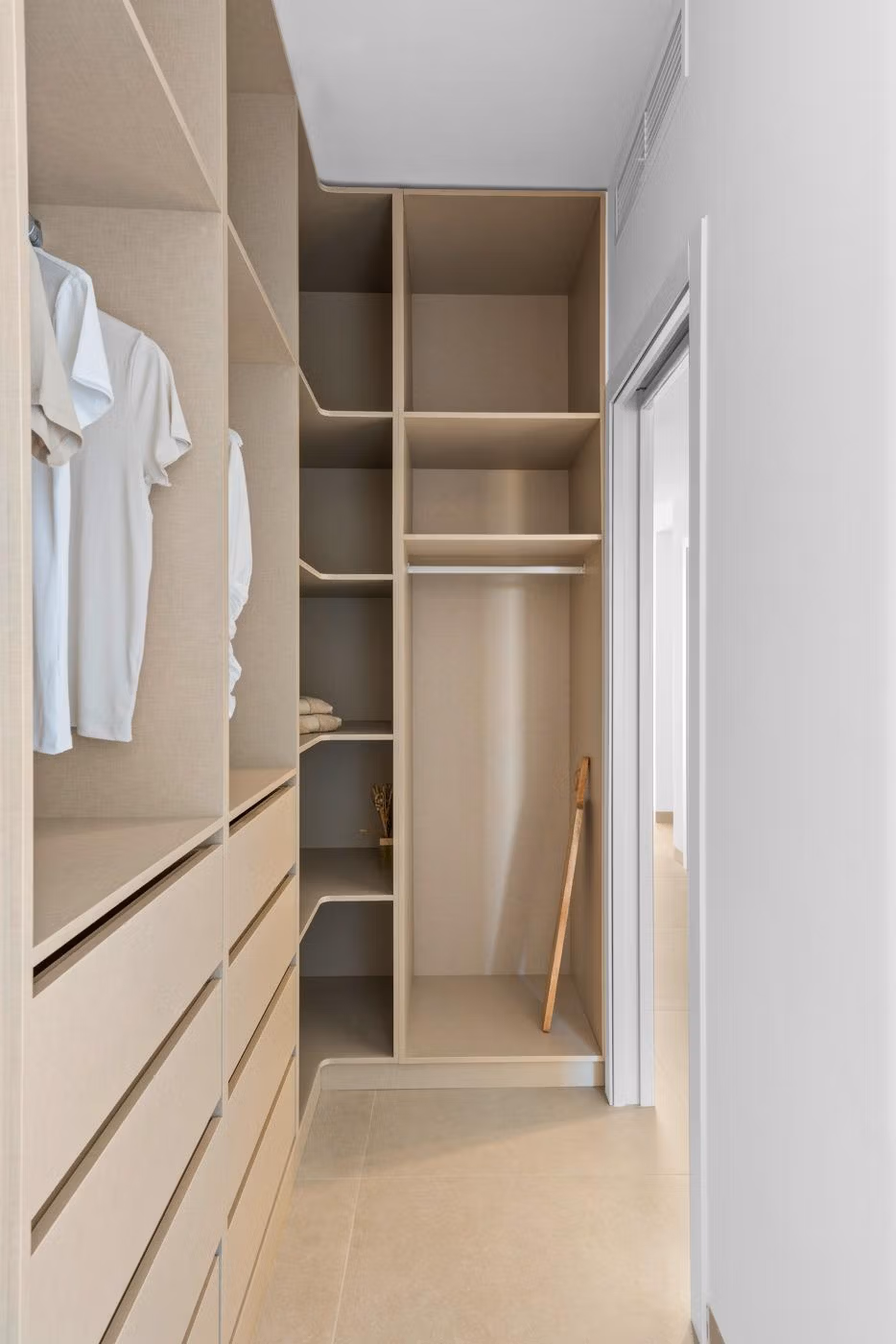 Bright and modern walk-in closet with sleek built-in storage in luxury 2 bedroom penthouse, Mar de Cristal.