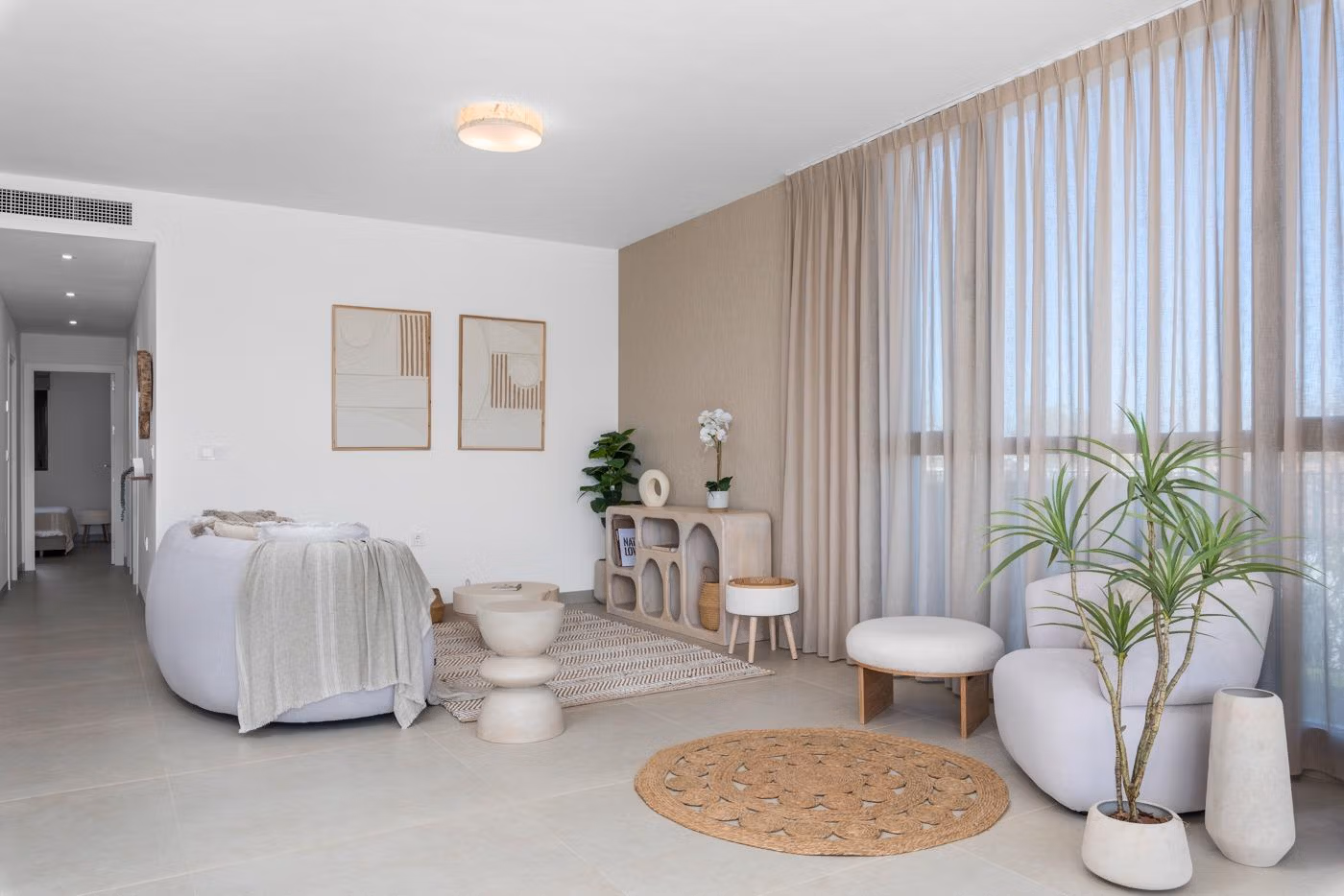 Bright, modern living area with floor-to-ceiling windows in a 2-bedroom penthouse with private solarium in Mar de Cristal.