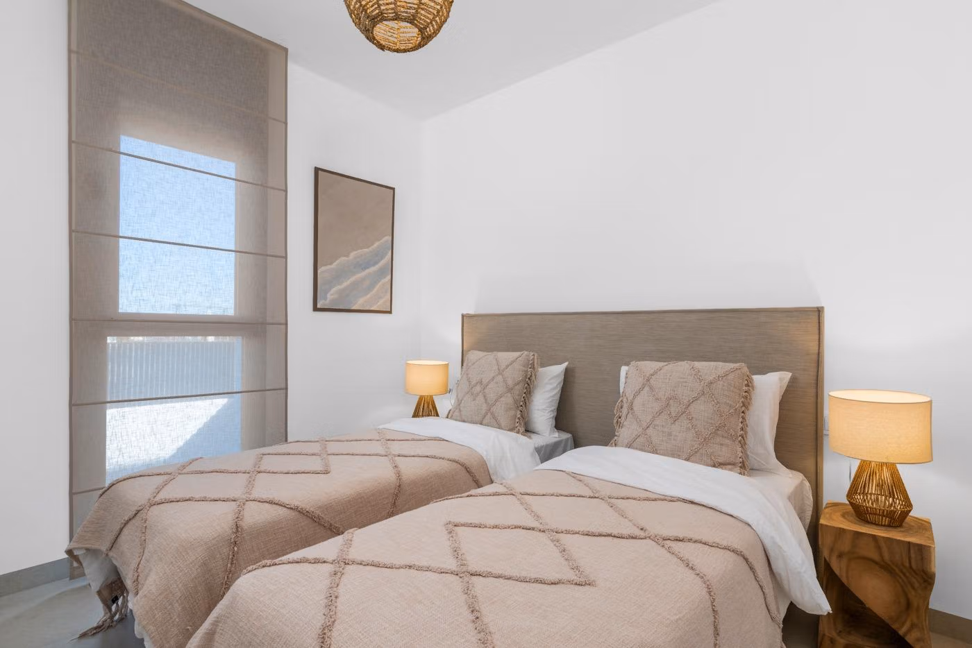 Bright, modern twin bedroom with textured beige linens in elevated new build penthouse with private solarium in Mar de Cristal.
