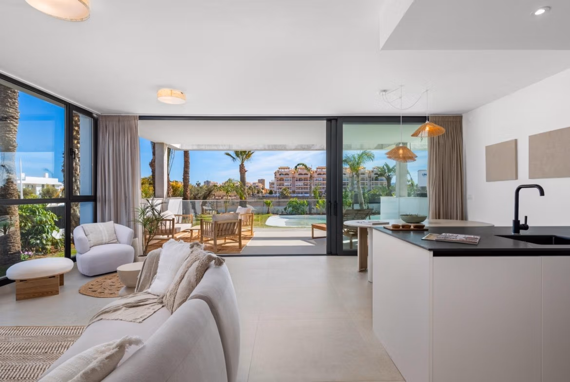 Bright open-plan living area with modern kitchen and spacious terrace in elevated 2-bedroom penthouse in Mar de Cristal.