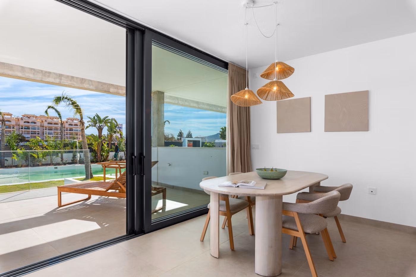 Bright modern dining area with sleek table and chairs opening to a sun-drenched terrace in a 2-bedroom penthouse in Mar de Cristal.