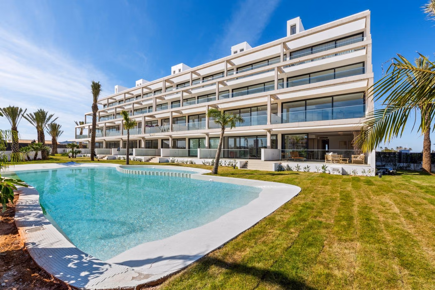 Modern elevated 2-bedroom penthouse in Mar de Cristal with spacious private terrace overlooking a pristine pool and lush gardens.