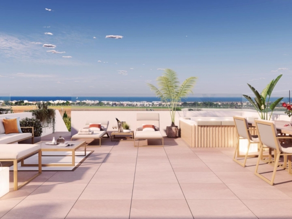 Spacious sun-drenched 2-bedroom penthouse solarium with modern lounge, dining area, and panoramic sea views in Pilar de la Horadada.