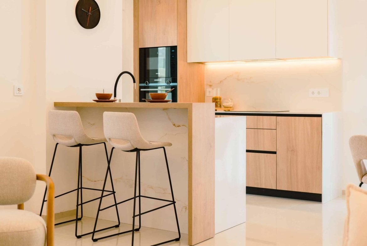 Bright modern kitchen with sleek cabinetry and breakfast bar in 2 bedroom ground floor bungalow in Doña Pepa, Rojales