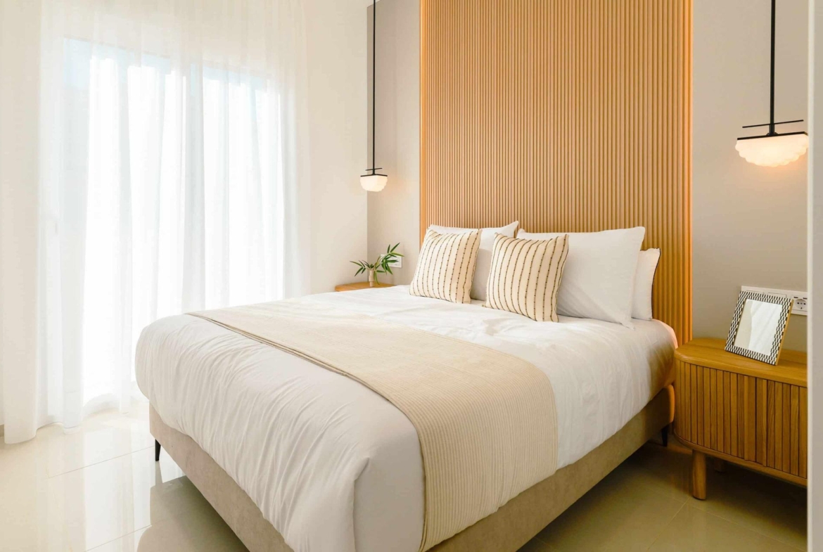 Bright, modern 2-bedroom ground floor bungalow bedroom with elegant wood paneling and soft natural light in Doña Pepa, Rojales.