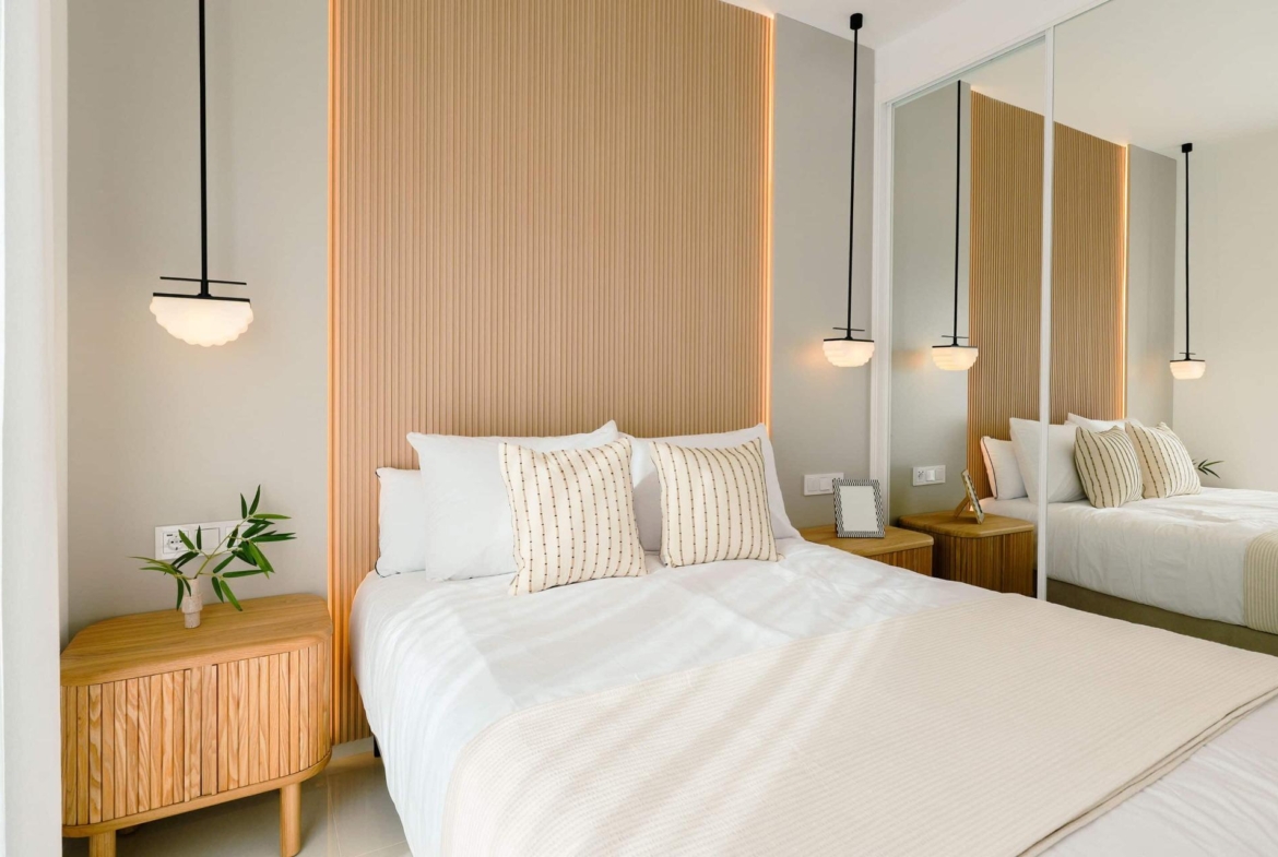 Bright, modern 2-bedroom ground floor bungalow bedroom with elegant wood paneling and soft lighting in Doña Pepa, Rojales.