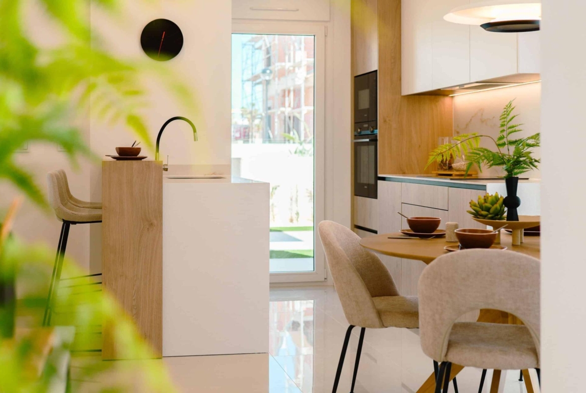 Bright modern open-plan kitchen and dining area in luxury 2-bedroom ground floor bungalow in Doña Pepa, Rojales.