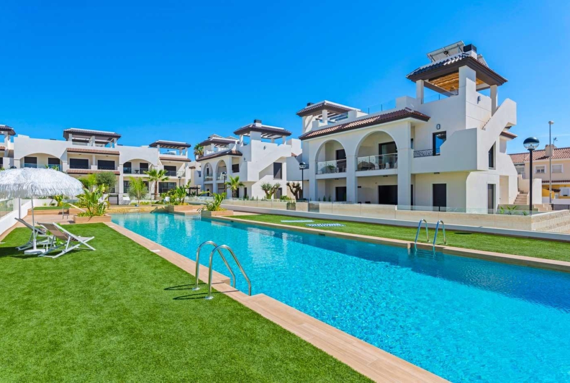 Modern 2 bedroom ground floor bungalow in Doña Pepa, Rojales with bright terrace and pristine communal pool under clear blue sky