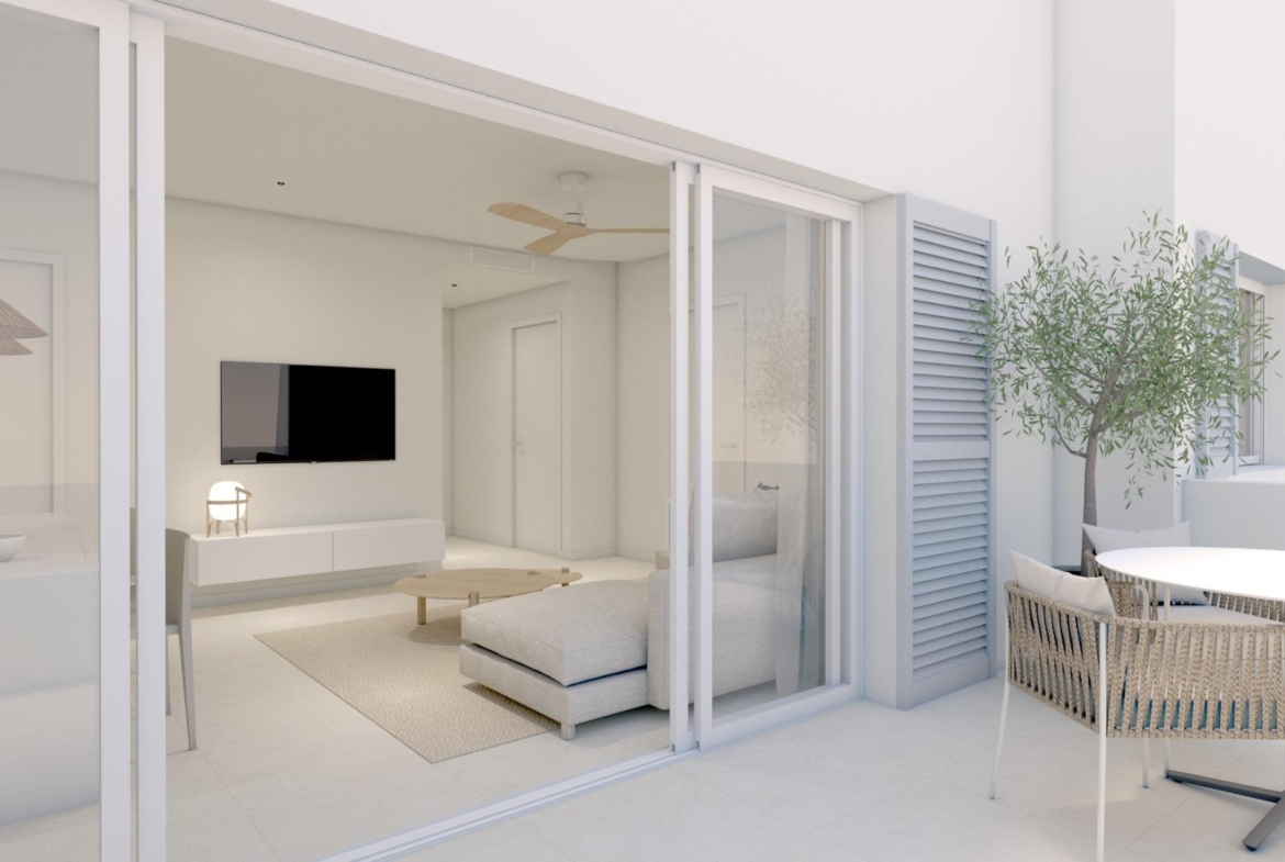 NEW-BUILD-RESIDENTIAL-COMPLEX-IN-TORRE-DE-LA-HORADADA-20 Bright modern living room with sleek furniture opening to a private sunlit terrace in a luxury Torre de la Horadada apartment.