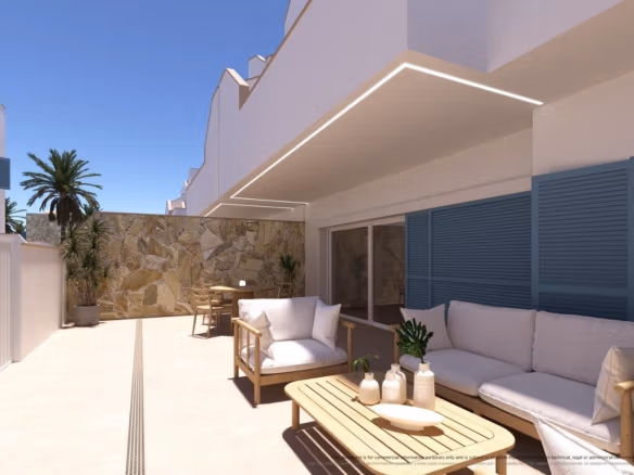 Ampia terrazza baciata dal sole di un appartamento al piano terra, con moderna zona salotto esterna ed elegante giardino a Torre de la Horadada