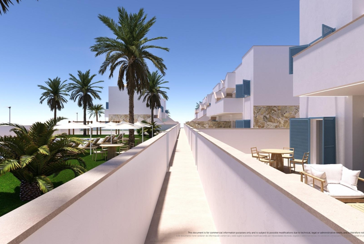 NEW-BUILD-RESIDENTIAL-COMPLEX-IN-TORRE-DE-LA-HORADADA-6 Sun-drenched top floor terrace with modern outdoor seating and lush palm landscaping in 3-bedroom apartment, Torre de la Horadada.