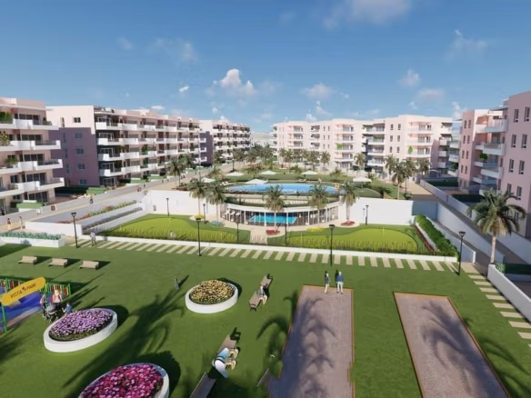 Modern communal garden with landscaped lawns, children's play area, and pool in luxury ground floor apartment complex in El Raso, Guardamar del Segura.