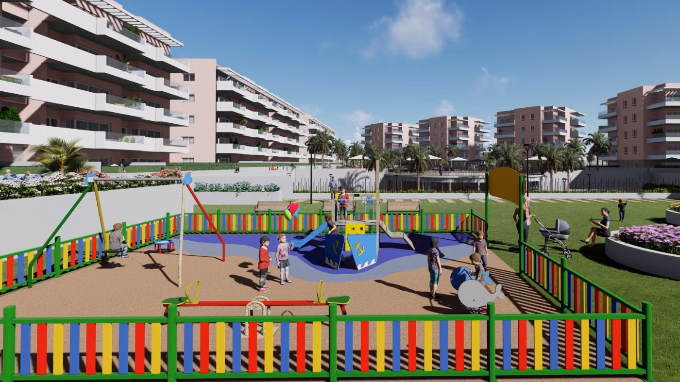 Vibrant fenced children's playground with colorful equipment in luxury new build penthouse complex in El Raso, Guardamar del Segura.