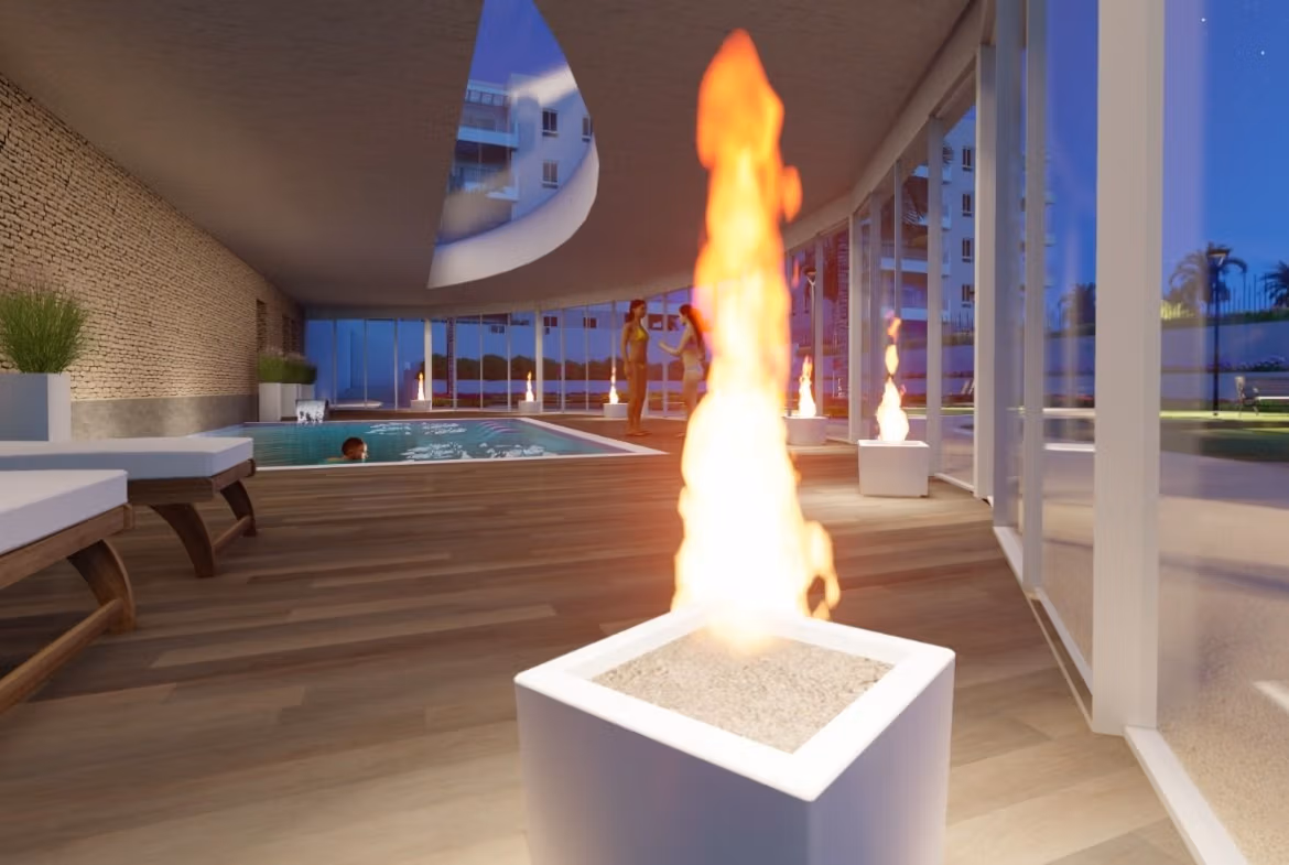 Modern sun-drenched indoor pool with cozy fire feature in luminous 3-bedroom penthouse with solarium in El Raso, Guardamar del Segura.