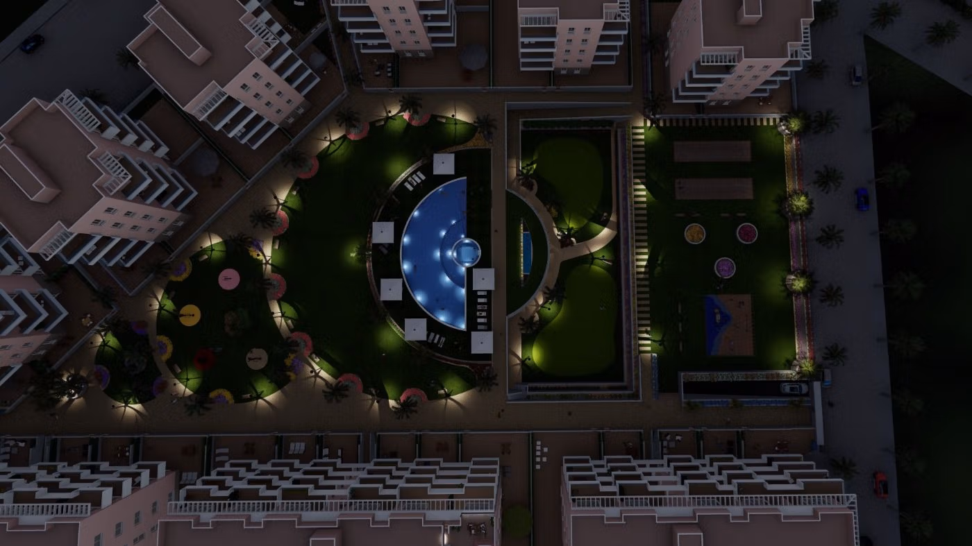 Luminous nighttime aerial view of landscaped gardens and illuminated pool in luxury 3-bedroom penthouse complex in El Raso, Guardamar del Segura.