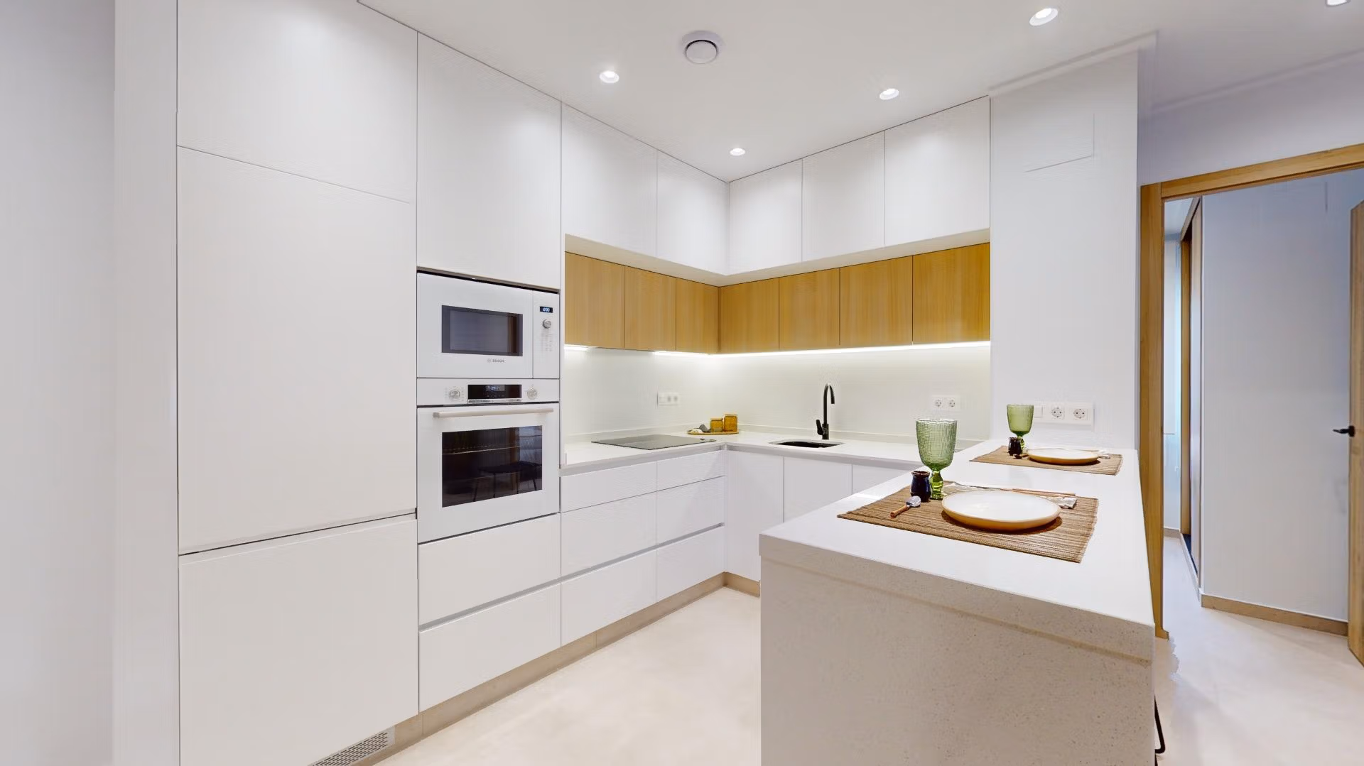 Bright modern kitchen with sleek cabinetry and integrated appliances in new 3-bedroom ground floor apartment, El Raso, Guardamar del Segura.