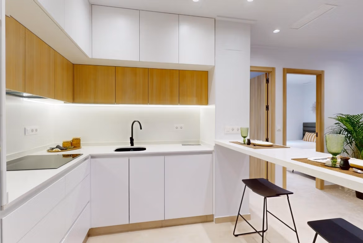 Modern sunlit kitchen with sleek cabinetry and breakfast bar in new 3-bedroom ground floor apartment, El Raso Guardamar del Segura