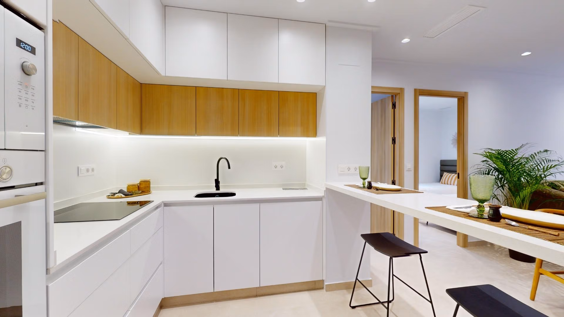 Modern sunlit kitchen with sleek cabinetry and breakfast bar in new 3-bedroom ground floor apartment, El Raso Guardamar del Segura