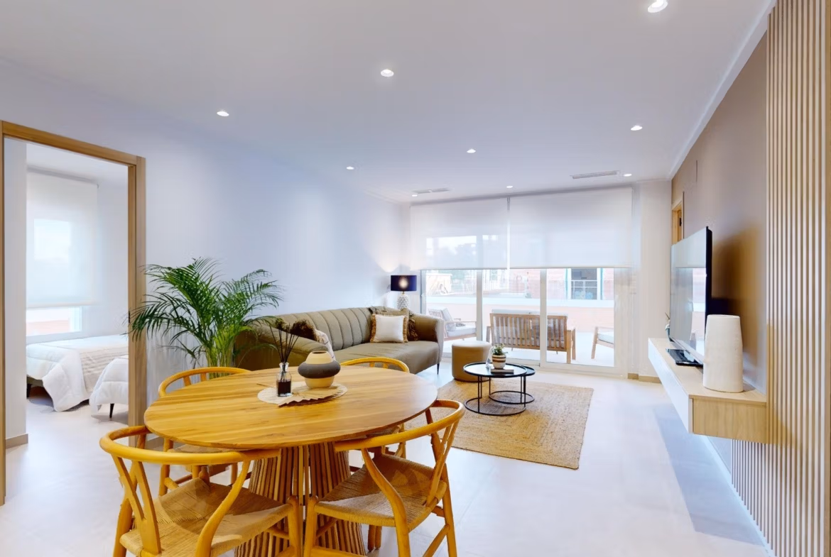 Bright modern open-plan living and dining area in luxurious 3-bedroom ground floor apartment with private garden in El Raso, Guardamar del Segura.