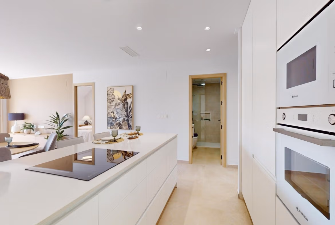 Bright modern kitchen with sleek built-in appliances and open-plan living in luxury 3-bedroom penthouse, El Raso, Guardamar del Segura.