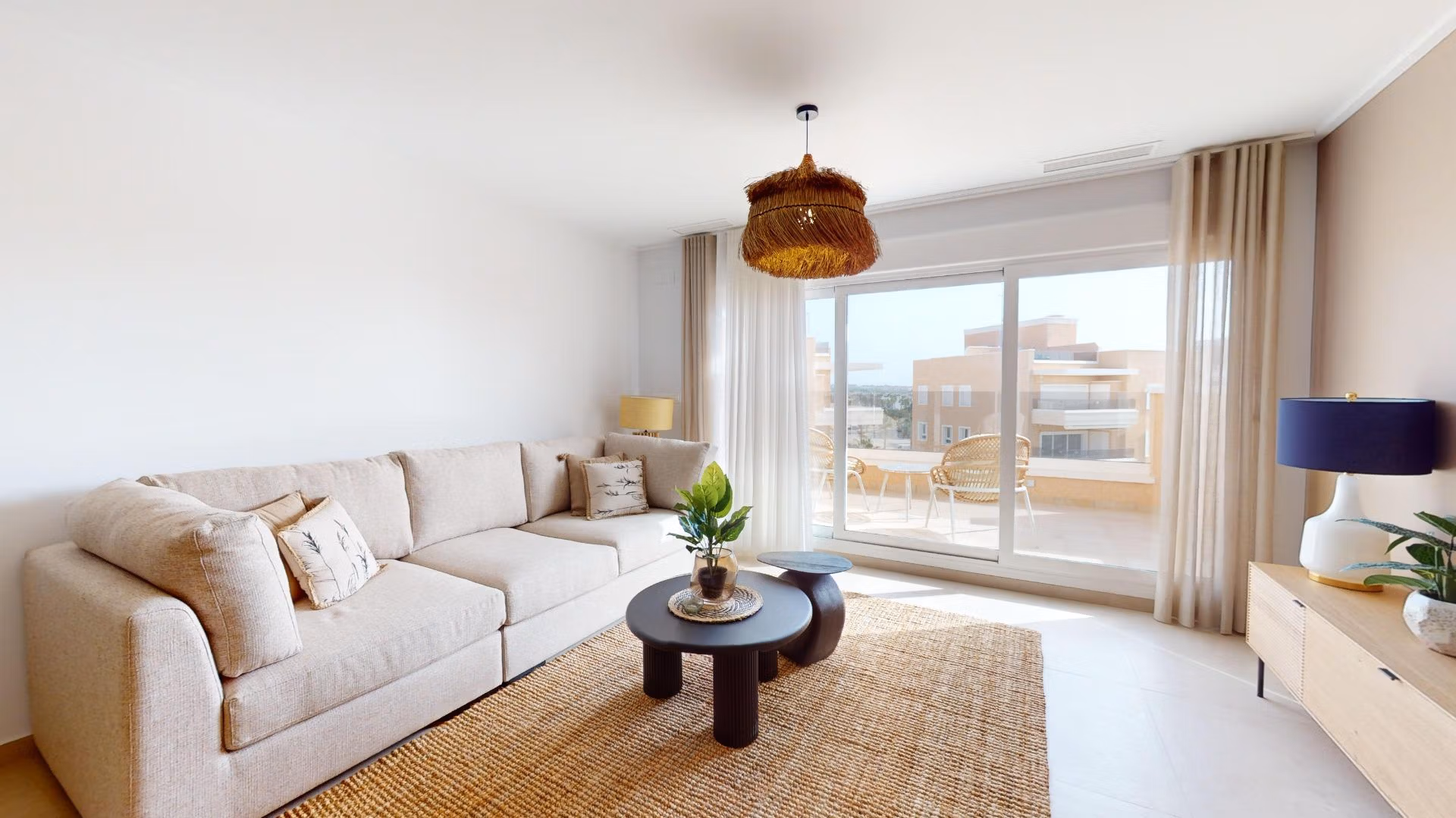 Bright, modern living room with elegant beige sofa and sunlit terrace in 3-bedroom penthouse with solarium, El Raso, Guardamar del Segura.