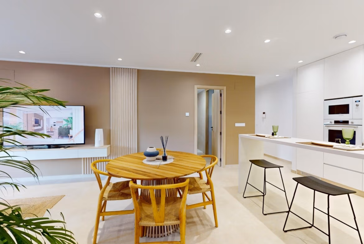 Bright modern open-plan kitchen and dining area in a new 3-bedroom ground floor apartment with private garden in El Raso, Guardamar del Segura